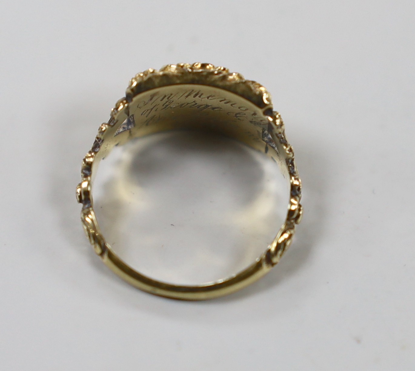 A George IV yellow metal and plaited hair set mourning ring, the ring head verso engraved 'In Memory of George & Ann Bolam, 1824', size O, gross weight 4.5 grams.